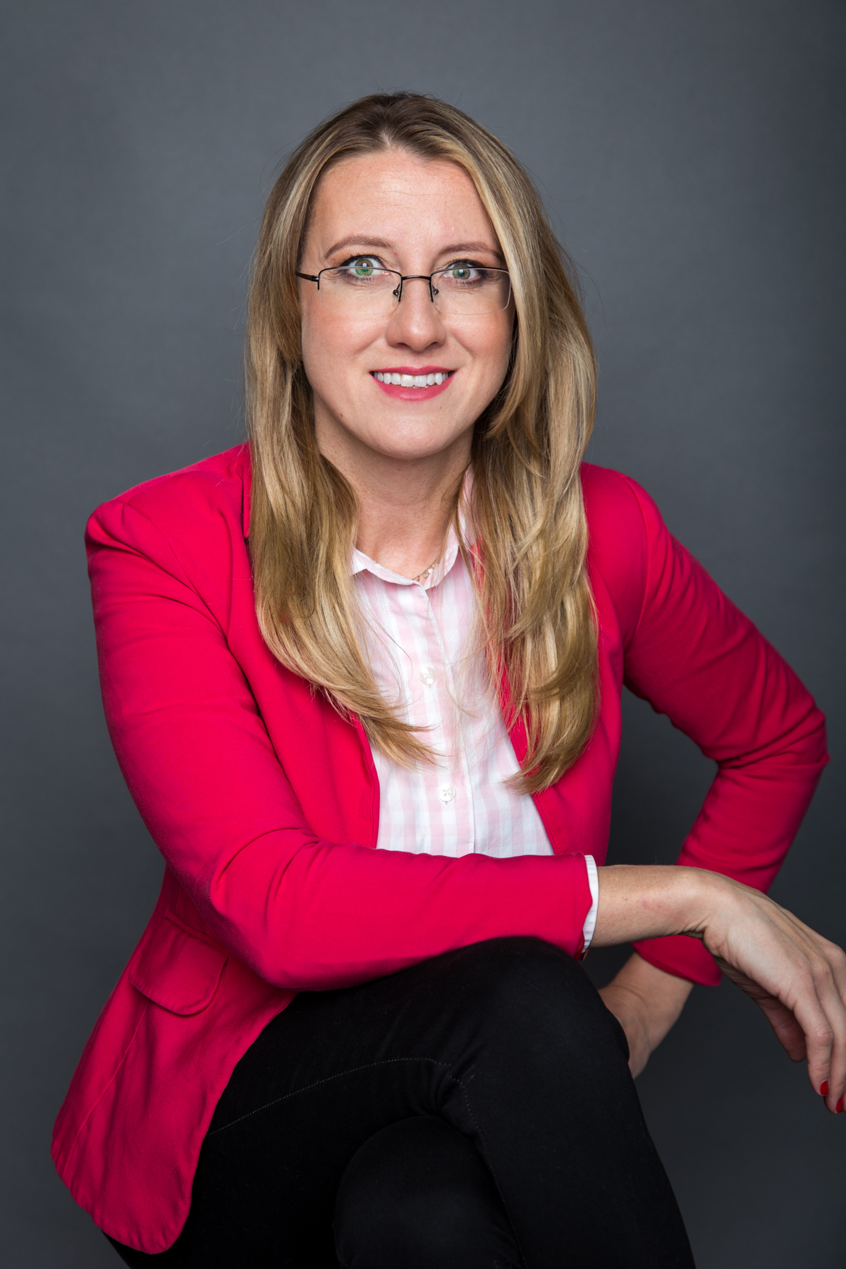 Marta Szymczak smiling in a red blazer