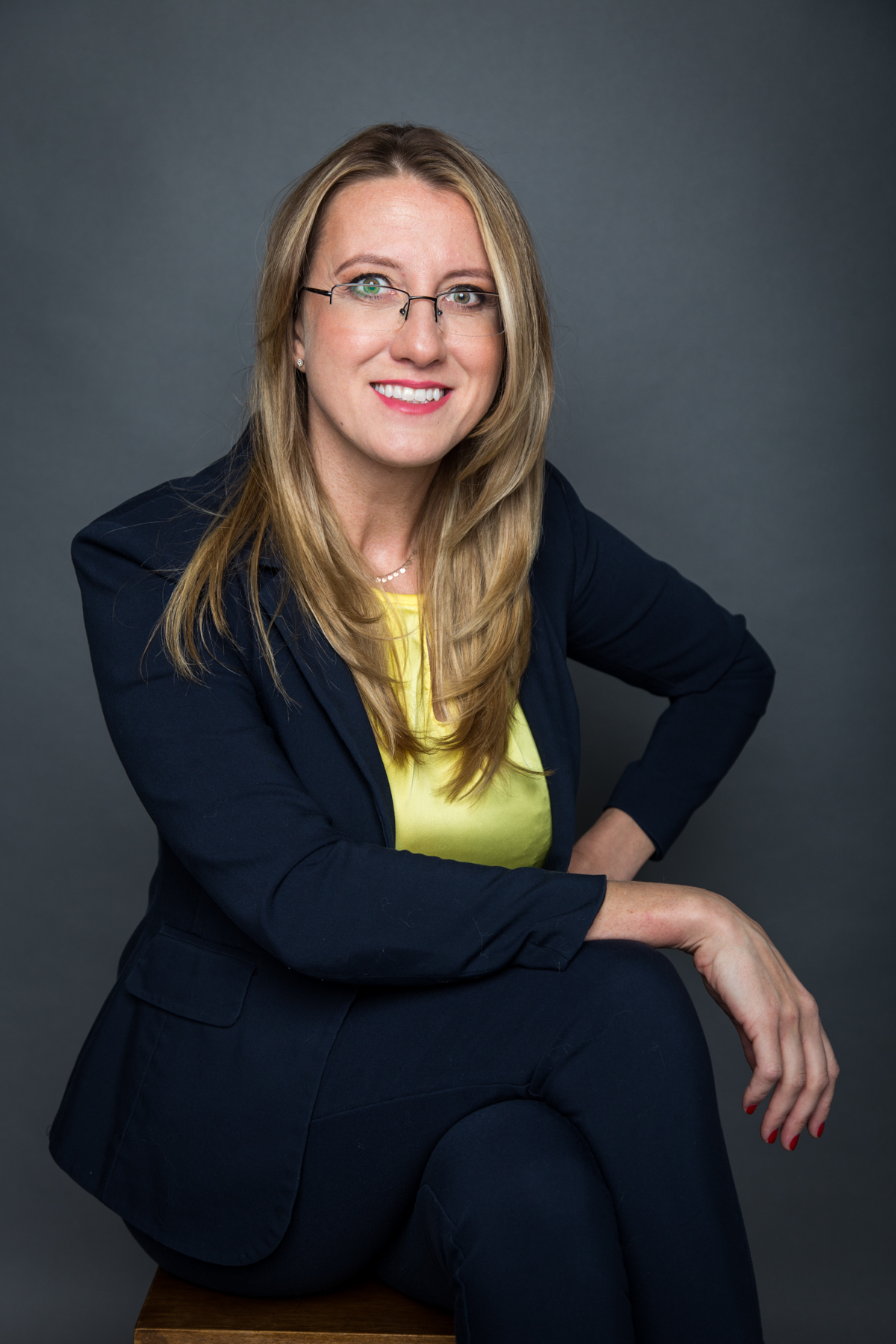 Marta Szymczak, certified life and health coach, smiling in a navy blazer and yellow top